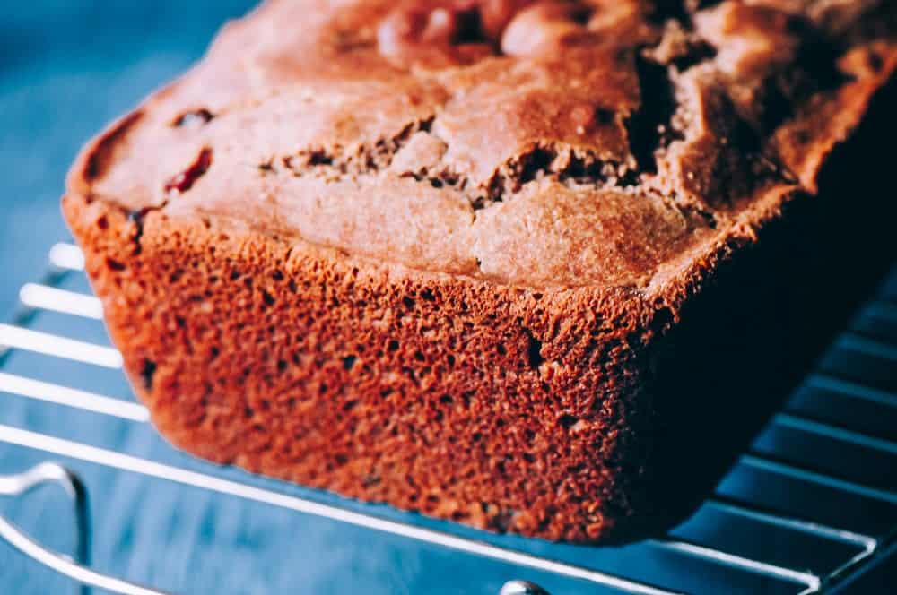 a loaf of gluten free cinnamon bread on a cooling rack