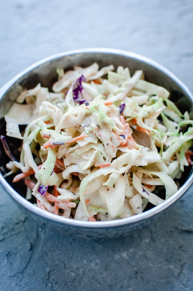  Creamy Vegan Coleslaw Recipe -  This creamy vegan take on a classic coleslaw salad recipe is rich, creamy, refreshing, crunchy, healthy and bursting with big flavor! This easy vegan coleslaw is perfect as is, or served in addition to your favorite summer meals. #vegancoleslaw #dairyfreecoleslaw  
