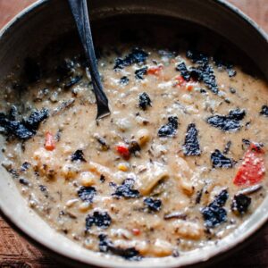A bowl of Instant Pot Wild Rice Soup with a spoon in it.