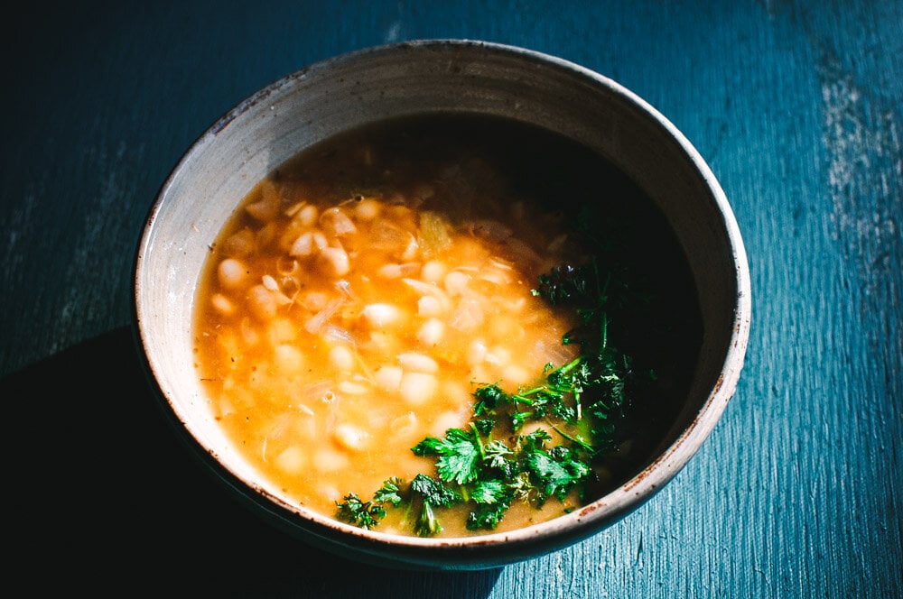   This comforting and heart-warming White Bean Soup is packed with flavorful Mexican spices for a truly delicious vegan soup recipe that is healthy, easy to make and can be made with soaked or unsoaked dry white beans! Both Instant Pot pressure cooker and stovetop instructions are included for this spicy, smoky, keto friendly soup! #whitebeansoup #whitebeansoupvegetarian #whitebeansoupvegan #instantpotwhitebeansoup  