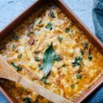 A square pan filled with butternut squash casserole