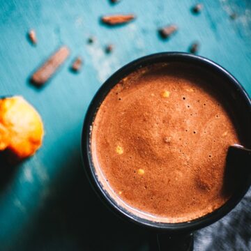 a top shot of a black mug of pumpkin spice hot chocolate