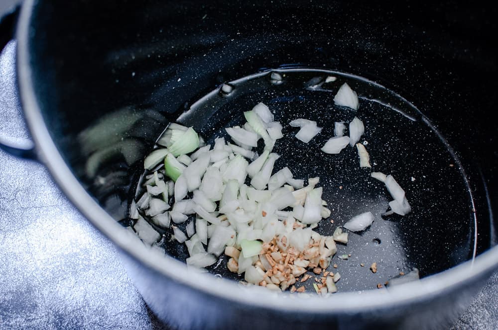  a stock pot filled with sauteed onions and garlic