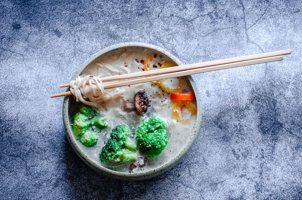 a bowl of vegan ramen on a cool gray background