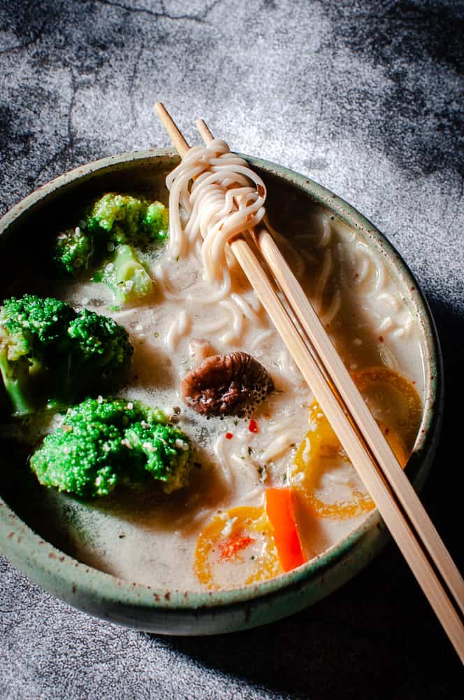 a vegan ramen bowl lit by sunlight