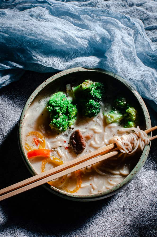 a green gauze cheesecloth above a bowl of gluten free vegan ramen