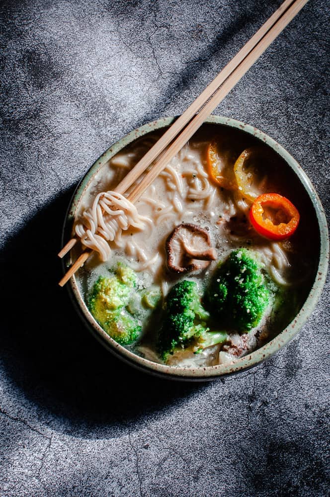 a top view of gluten free ramen noodles topped with pepper rings and mushrooms