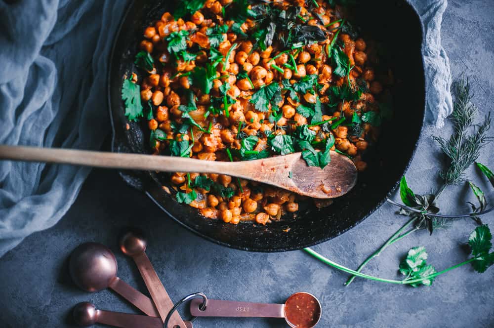 a cast iron skillet filled with harissa chickpeas