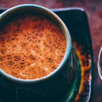 a mug of golden milk sprinkled with cinnamon