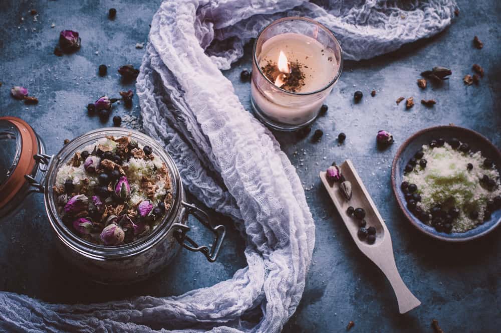 a top view of juniper bath salts next to candle