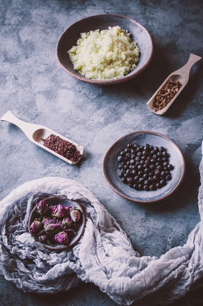 a flatlay of bath salts juniper berries rose buds