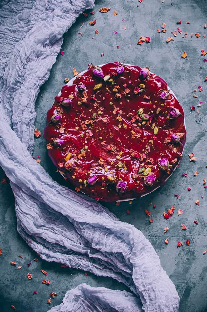 top view red rose cake next to lavender clot