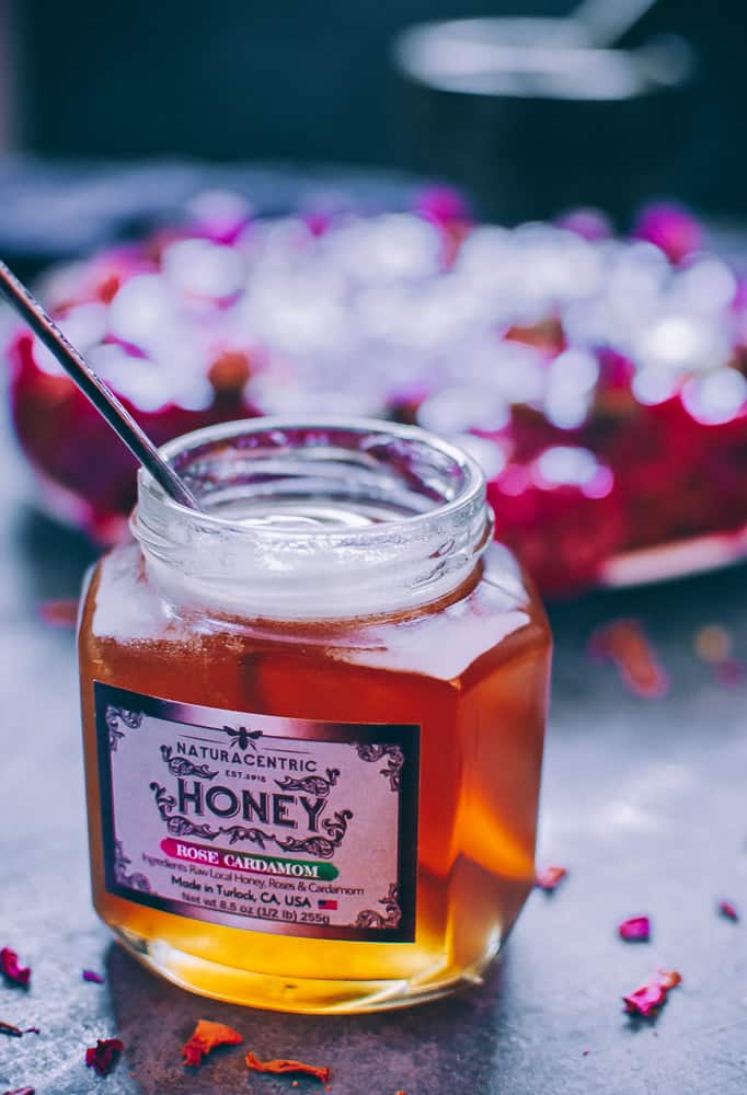 an open jar of naturacentric rose cardamom honey