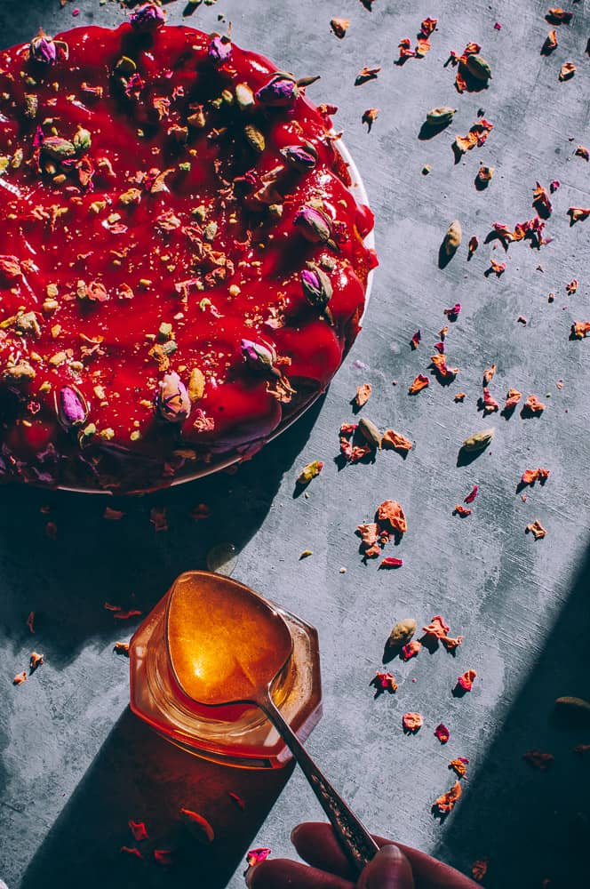 sunlit jar honey next to cake