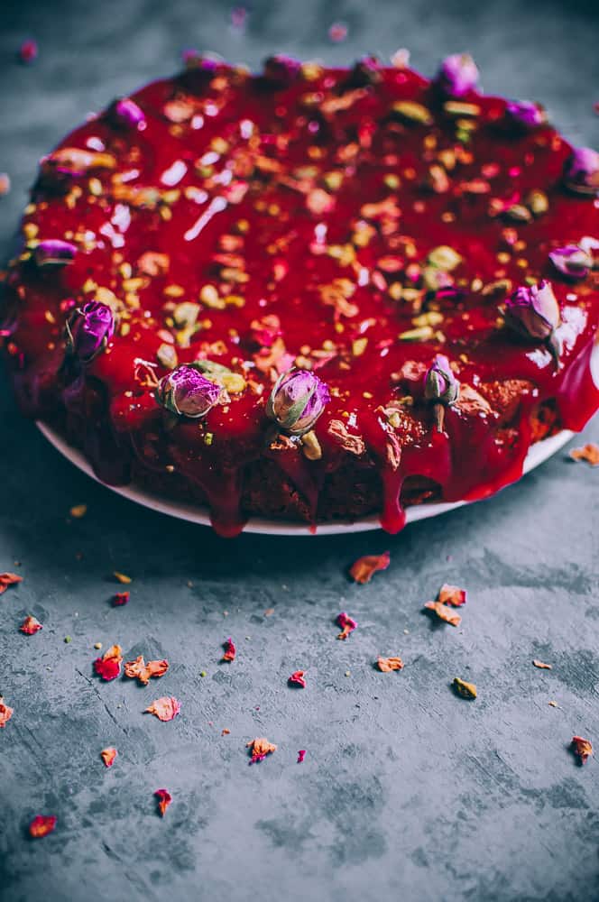 cake drizzled with red glaze and rose
