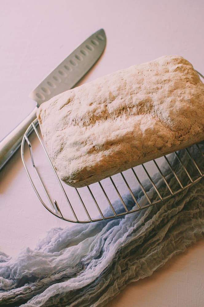 gluten free bread on cooling rack next to knife