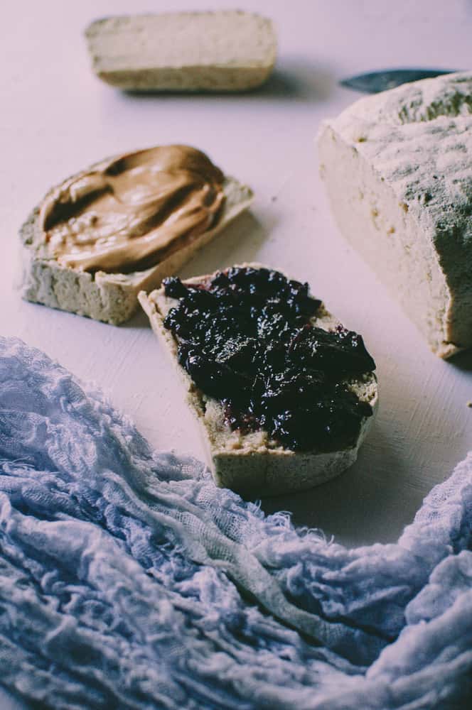 cut pieces of gluten free bread slathered with peanut butter and jelly open faced