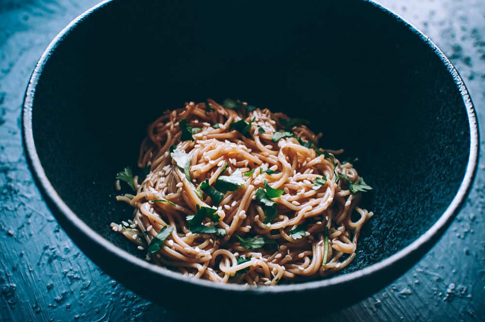 a black bowl of noodles