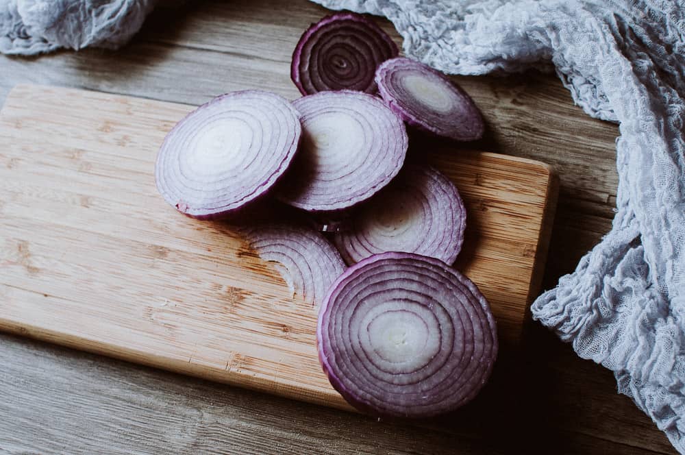 sliced onion resting on a cutting board