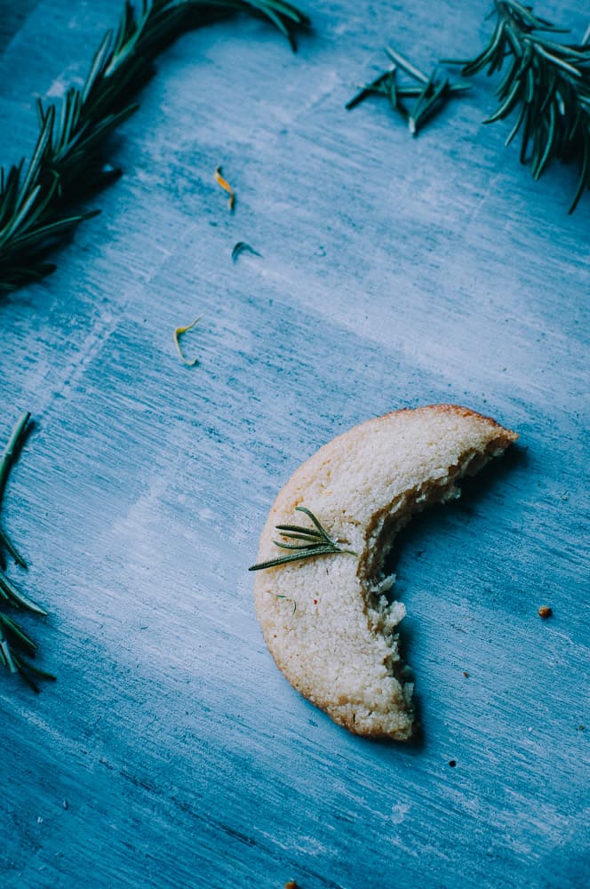  a crescent shaped cookie a bite taken out of a gluten free shortbread cookie