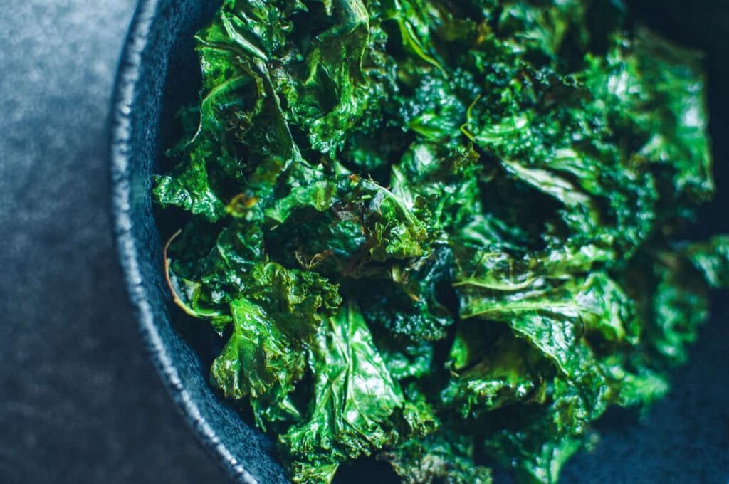 a close up of a bowl of air fryer kale chips