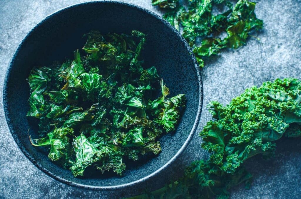 a black bowl filled with kale chips