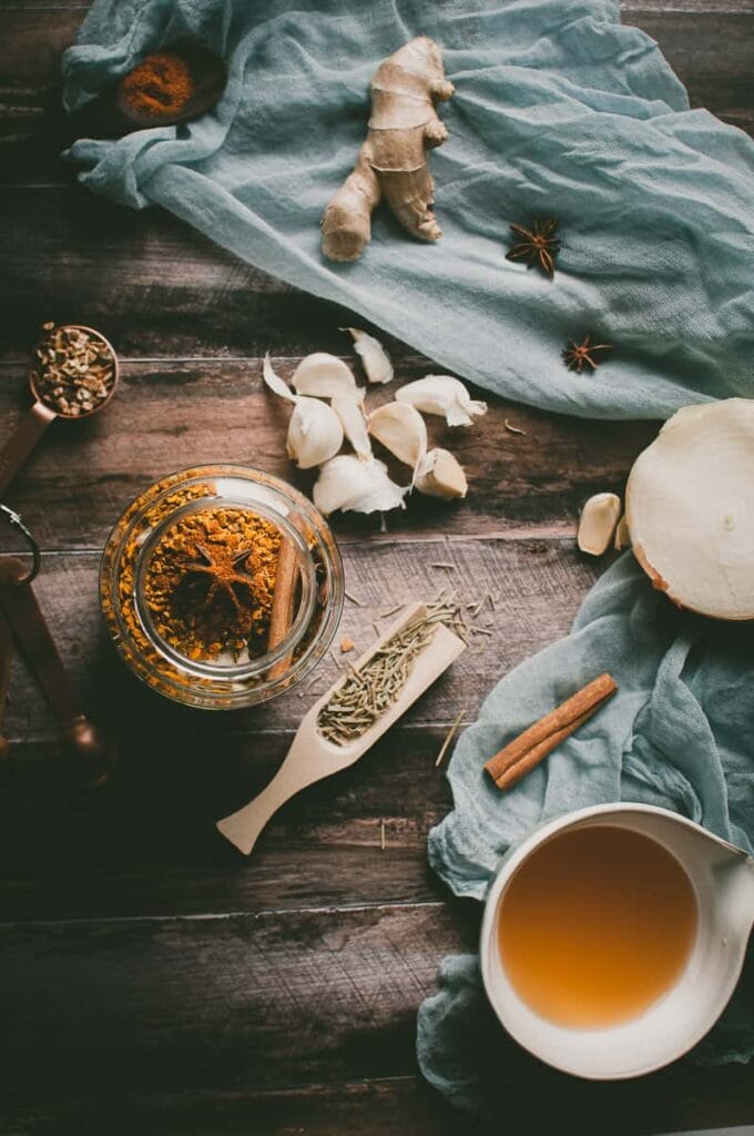 a styled flatlay of fire cider ingredients on a wooden background