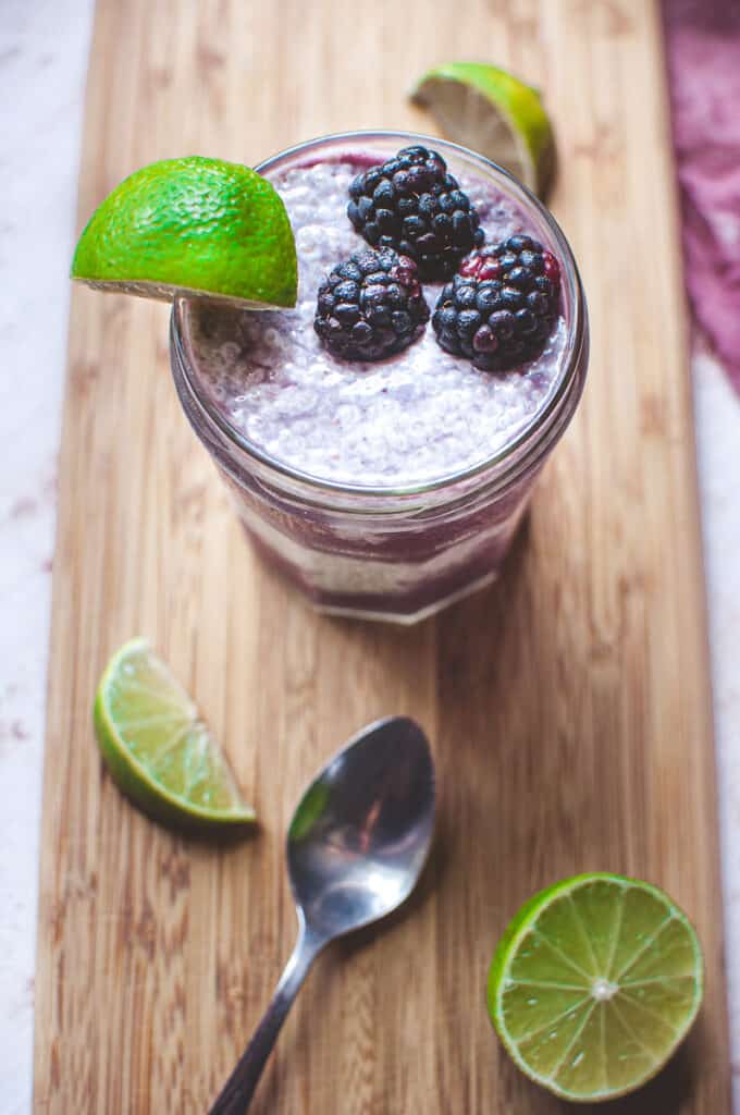 a top view shot of chia seed parfait garnished with lime and fresh blackberries