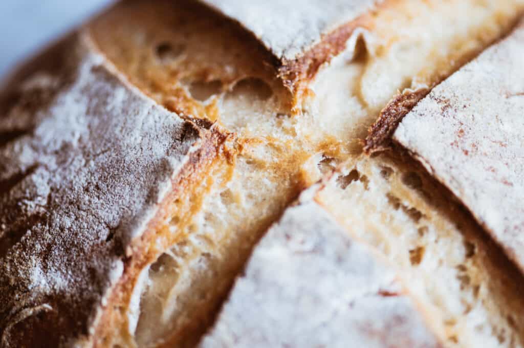 a close up shot of the scoring lines on a loaf of gluten free sourdough bread