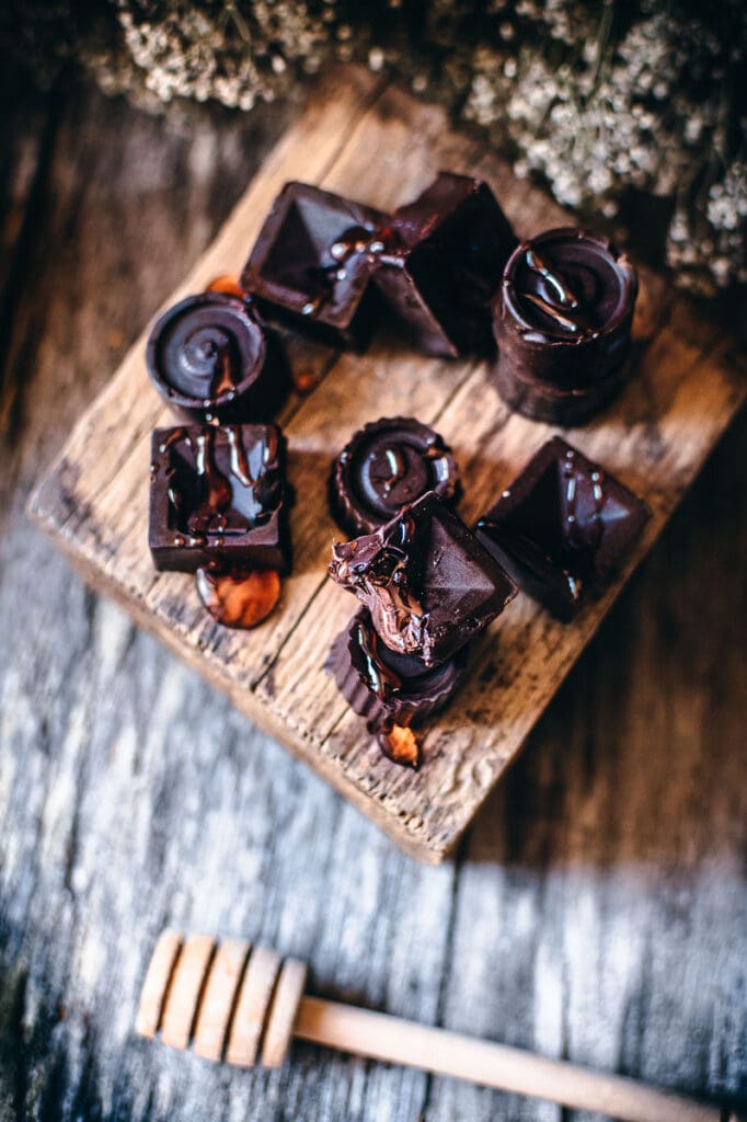 a stack of honey chocolates on a wooden block