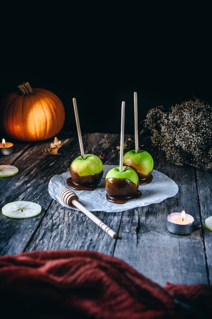 honey candied apples on a wooden backdrop