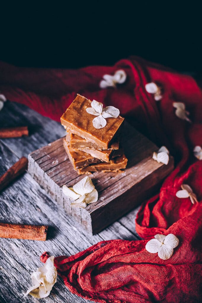 dark moody freezer fudge on wooden backdrop with dried flowers