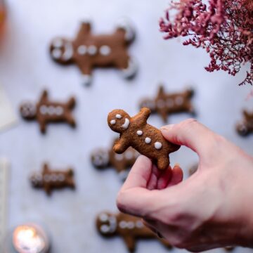 a hand holding a gingerbread man