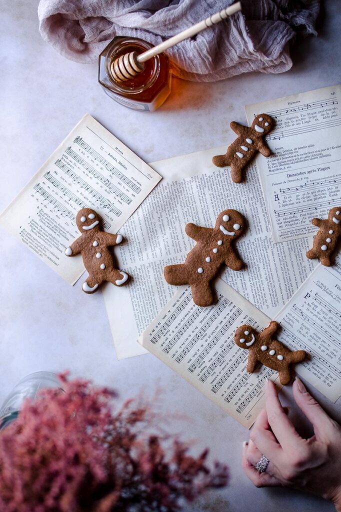 music sheets and a hand reaching for a gingerbread man