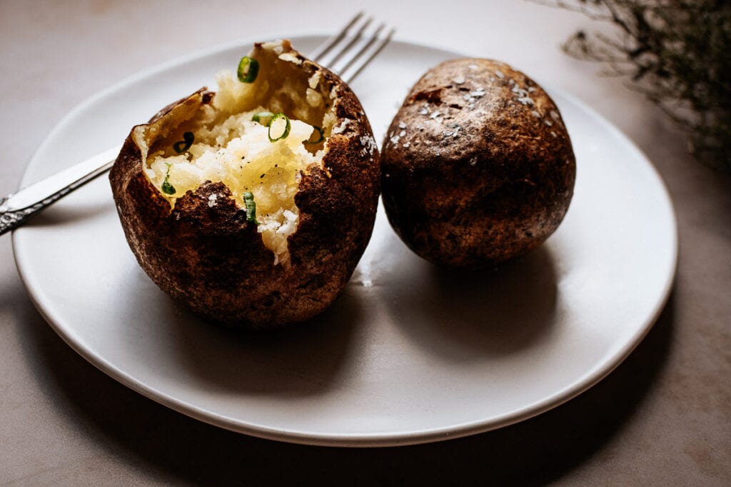 baked potatoes with butter and onions