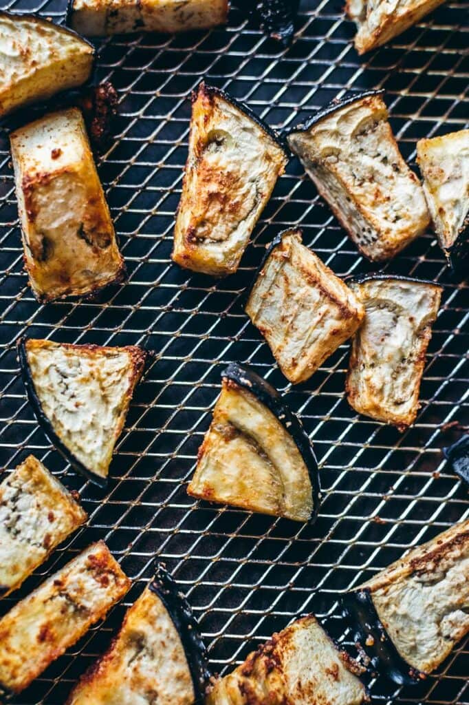 Air fryer eggplant slices on a cooling rack.