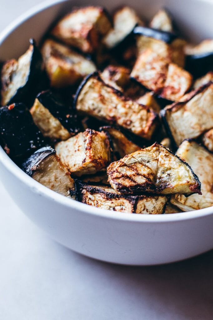 Air fried eggplant in a white bowl.