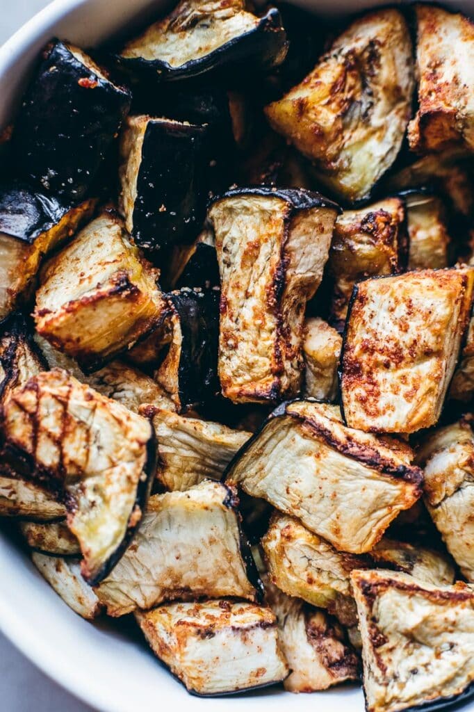 Air fried eggplant in a white bowl.