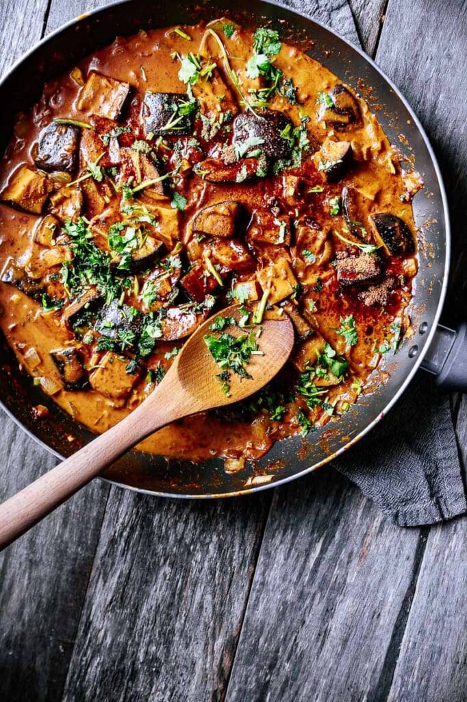 a pan filled with creamy aubergine curry