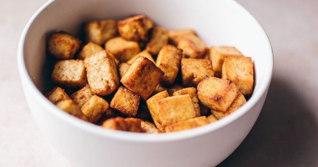 a white bowl filled with crispy tofu bites