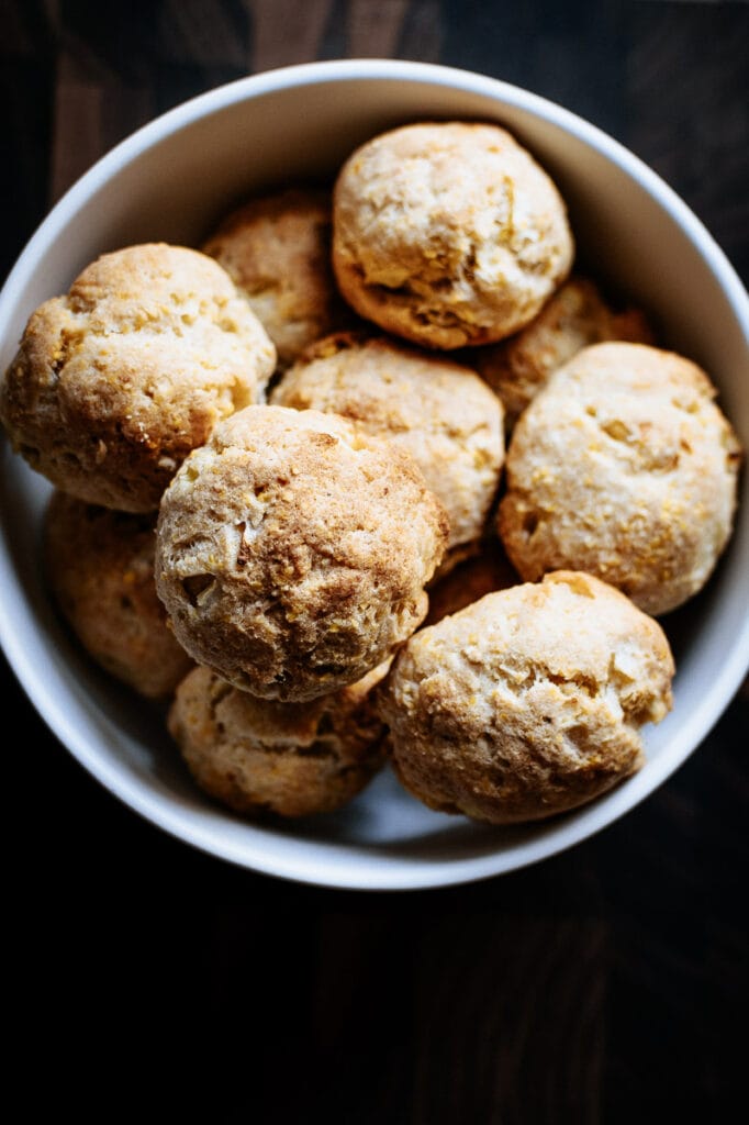 a mound of hush puppies in a white bowl