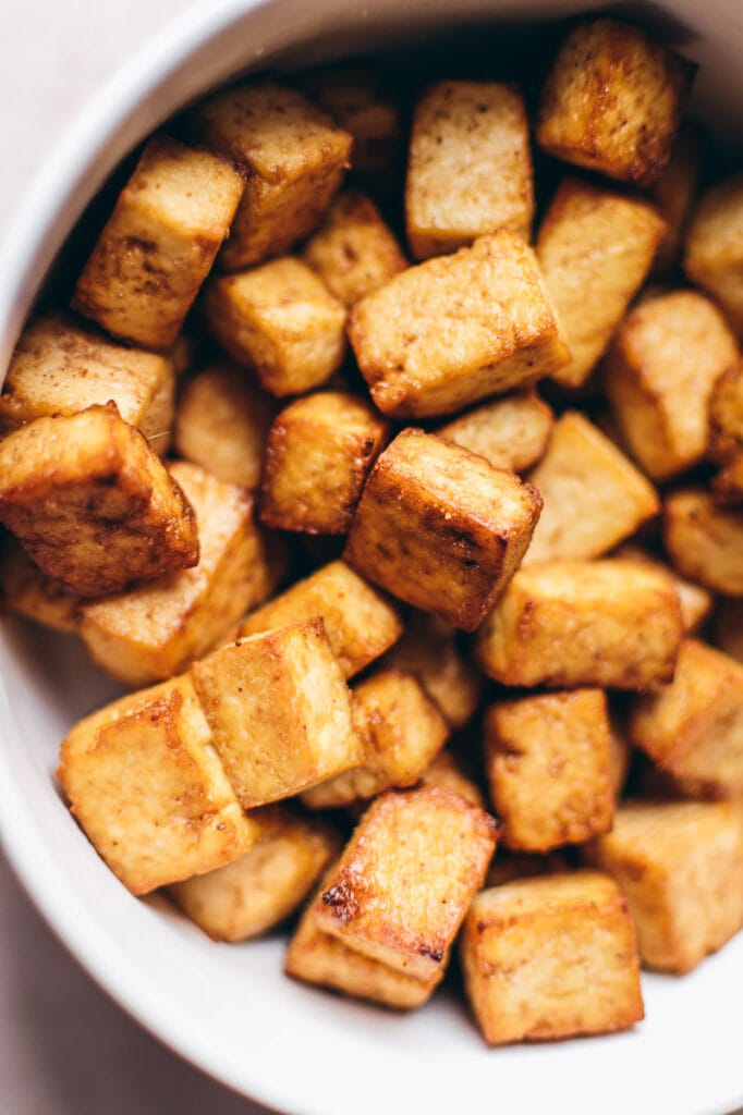 Close shot of tofu that's been cooked in an air fryer.