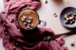chocolate moon milk with rose cardamom honey in a clear mug