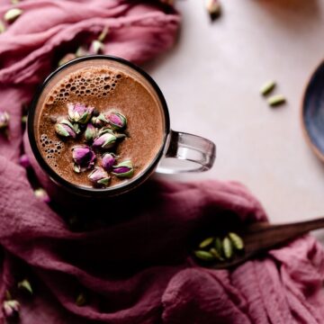 chocolate moon milk with rose cardamom honey in a clear mug