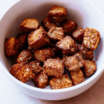 a white bowl filled with crispy tempeh