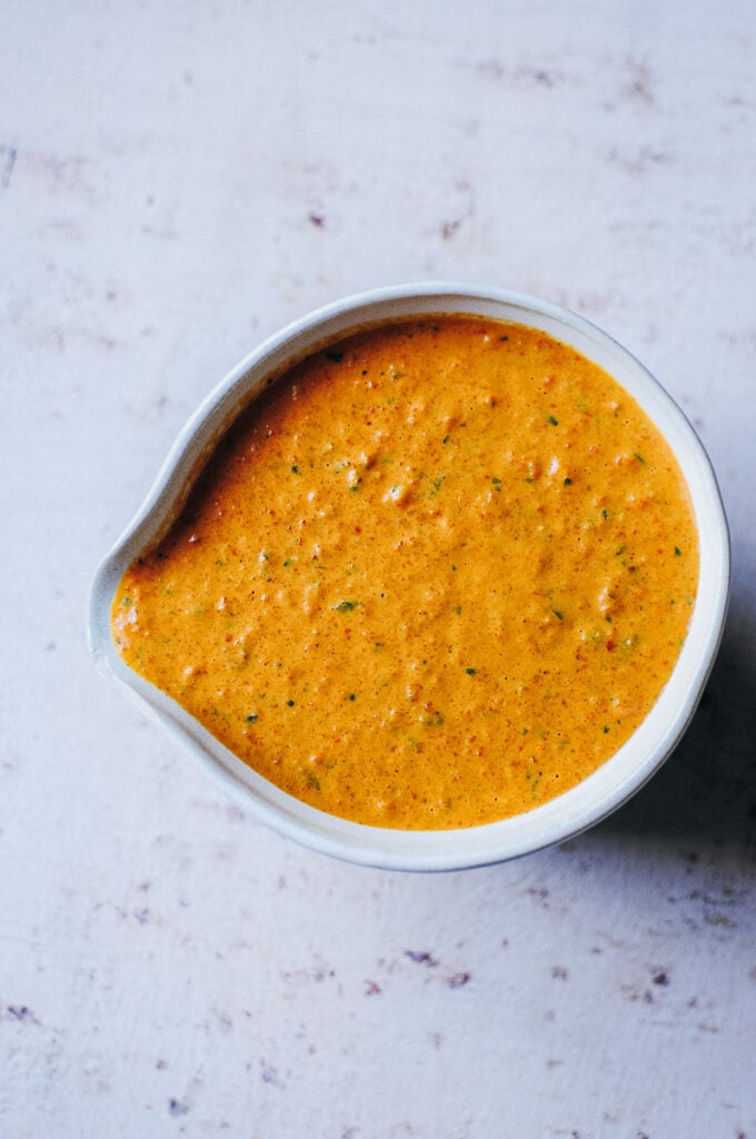 a bowl filled with red smoky romesco