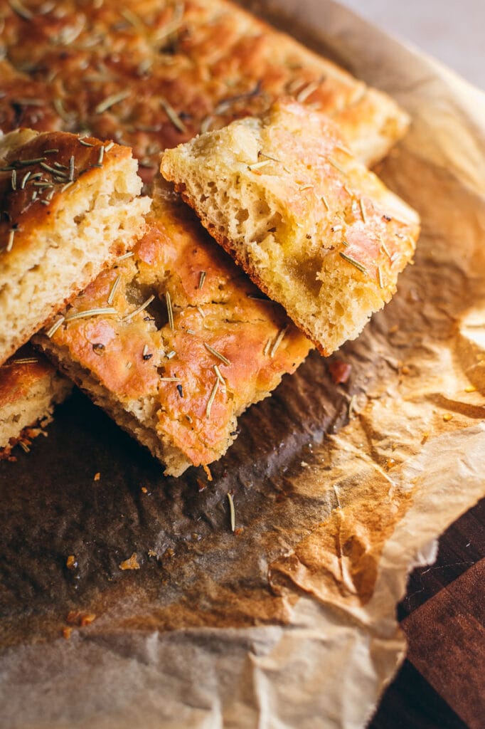 golden slices of gluten free focaccia lit by the afternoon sun