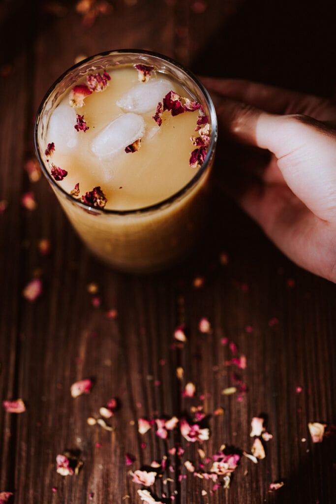 an iced rooibos tea latte lit by the sunset