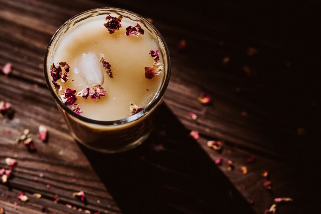 a rose rooibos latte lit by evening sun taking on a golden glow
