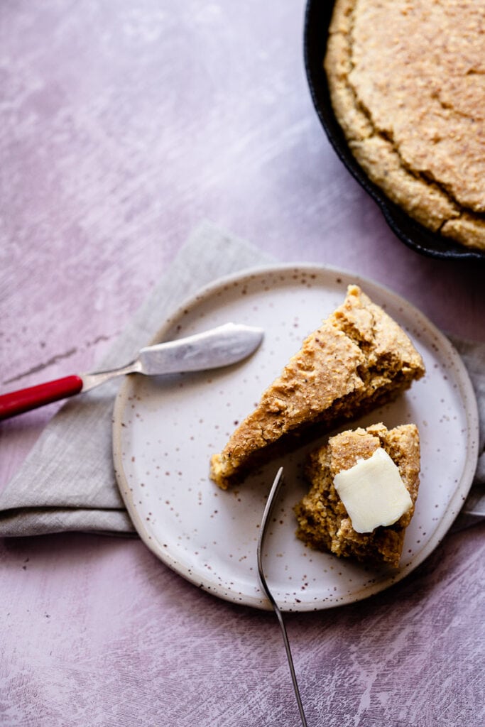 a plate of buttered gluten free vegan cornbread without eggs